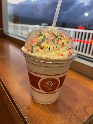 Savory Strawberry milkshake with whipped cream and sprinkles