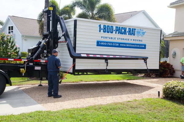 1-800-PACK-RAT container being lowered from a mini-mover.