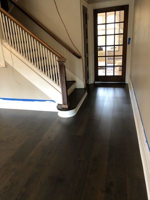 Existing hardwood and subflooring removed, new plywood with leveling installed. And Prefinished engineered wood floor installed on top.