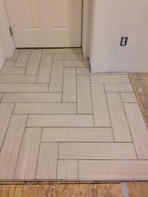 Foyer entrance with tile installed in a unique pattern