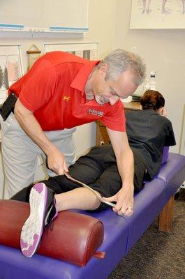 Dr Sok working on a patient utilizing the GRASTON technique to restore function to the area.