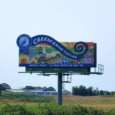 Meadow billboard with colorful illustration ad for Blue Heron cheese company in Tillamook, Oregon