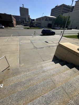 Another view of the dilapidated stairs and sidewalk.