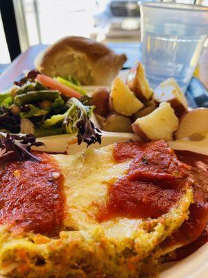 Veggie lasagna topped with spicy arrabbiata sauce, roasted potatoes, Salad and bread