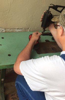 Sewing the strap with gigantic Singer machine that has repaired many saddles