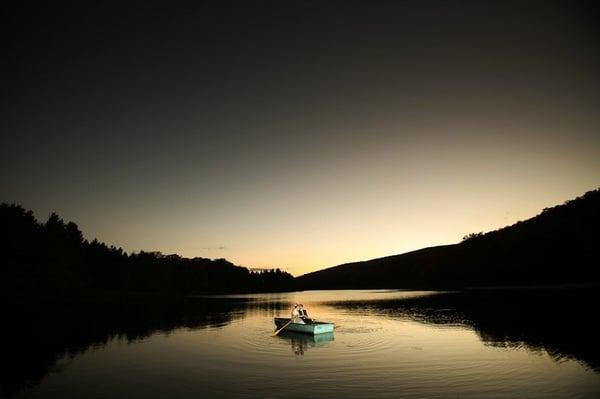 On a row boat, in a lake, in the Catskills, at dusk. In our wedding duds. AWESOME.