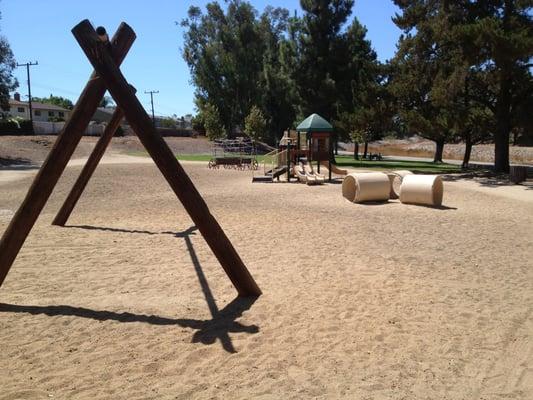 Small playground including a swing set without swings and a wagon