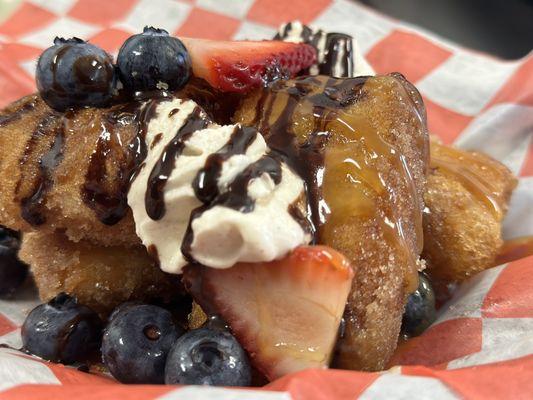 Loaded Fluffies- croissant beignets topped with homemade cinnamon vanilla, berries, caramel sauce, and chocolate sauce.