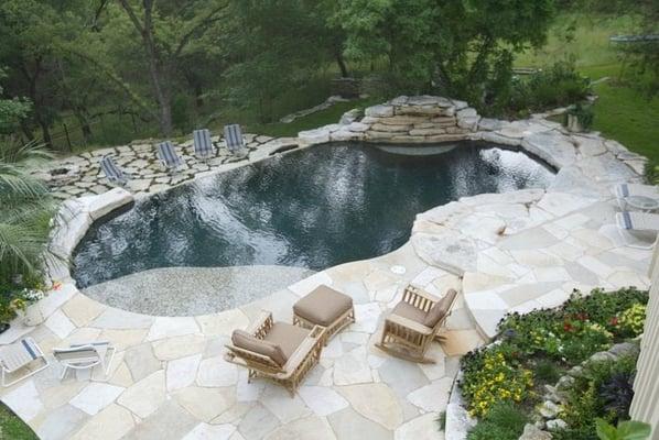 Natural style free form pool with spa on lower level.