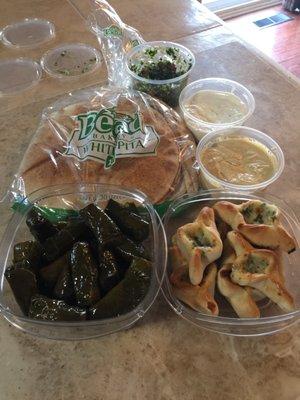 Mesa of pita flat bread, cheese breads, vegetarian stuffed grape leaves, hummus, garlic dip & taboulli.