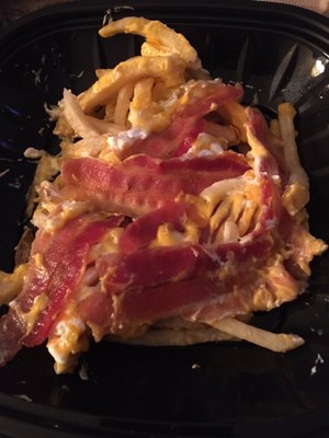 Who just throws slices of bacon on top of fries?