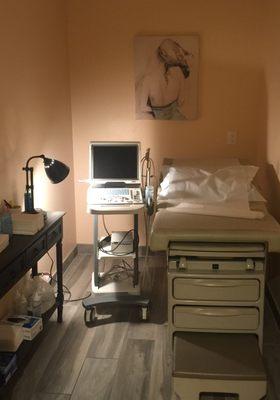 Ultrasound room with dim lighting to create a warm and relaxing ambiance.