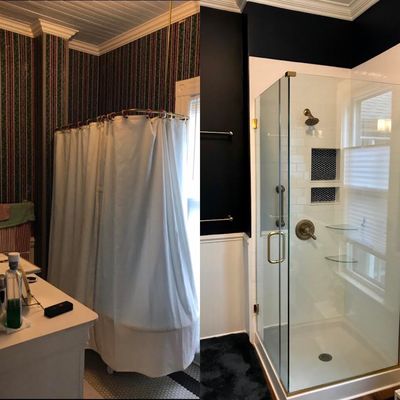 Navy bathroom with hardwood floors and glass shower enclosure.