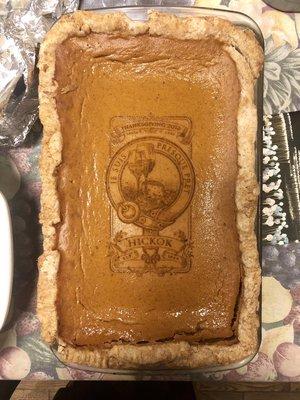 A delicious, homemade pumpkin pie, customized with the family crest that was also designed here!