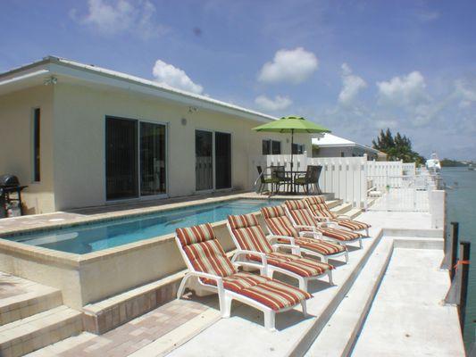 Casa Mar Azul 3- View of the pool and deep waterway canal with a 46 foot dock, weber gas grill and fish cleaning table.