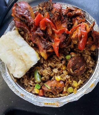 Special Spanish Fried Rice with sausage, pork, chicken, and veg. On top is stewed chicken, and some yucca. Very good.