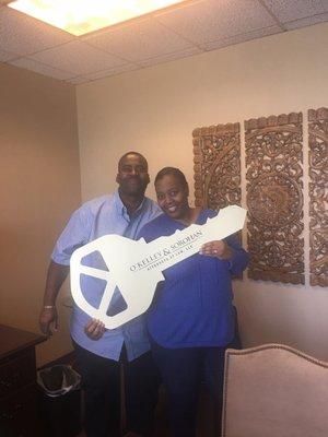 Happy homeowners with the closing key!