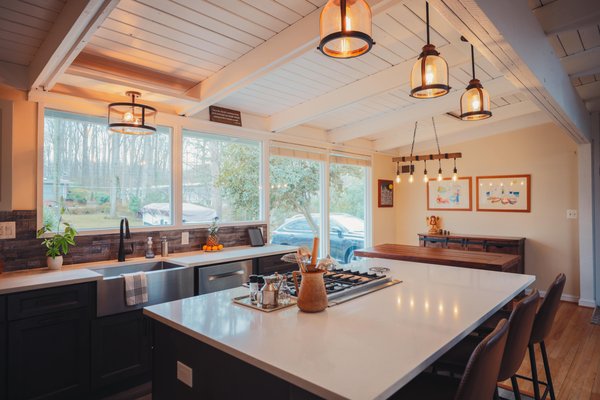 Kitchen remodel with white granite countertop and stainless steel appliances