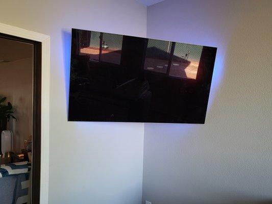 55" LG OLED single arm bracket corner mounted onto a wall with an in-wall sliding door.