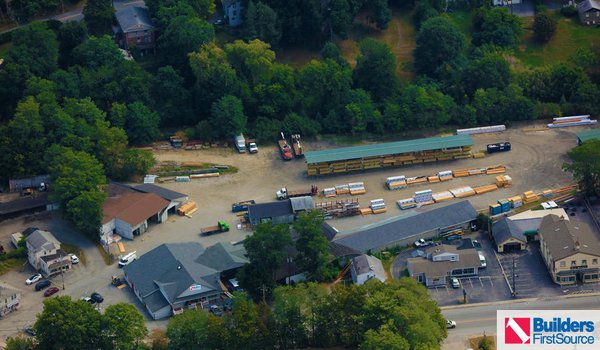 Building materials supplier Builders FirstSource's forklift is moving wood roof trusses.