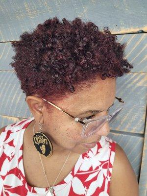 Red color and cut on natural coily hair.