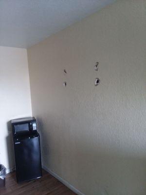 4 holes in the wall from "previous guests fight"