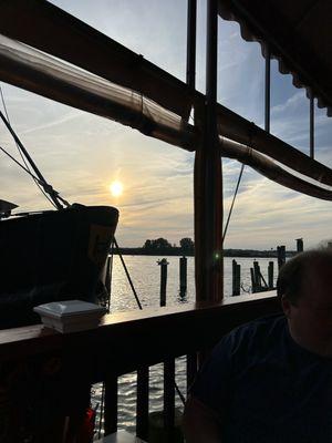 Seating on porch, dockside. Beautiful view of the sunset.