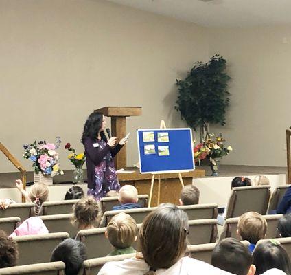 Ms. Jill in chapel teaching the children about the lost sheep.