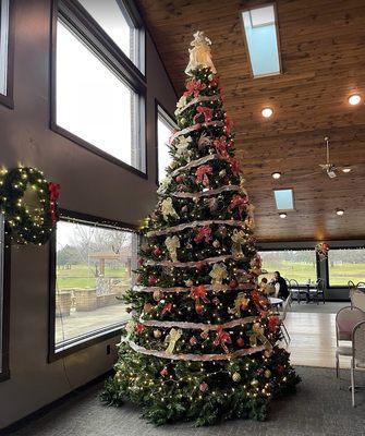 Christmas tree in front of windows and dance floor area