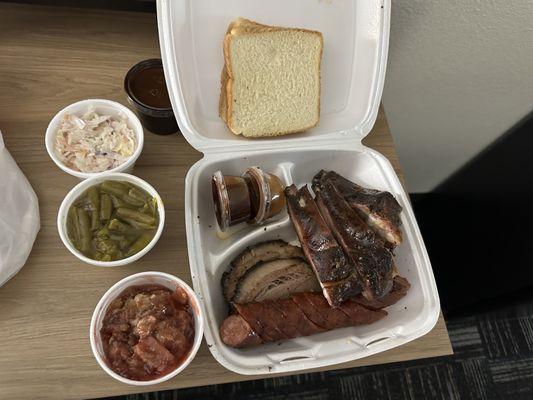 The Meat 3 combo with cole slaw, green beans, white bread, and strawberry cobbler