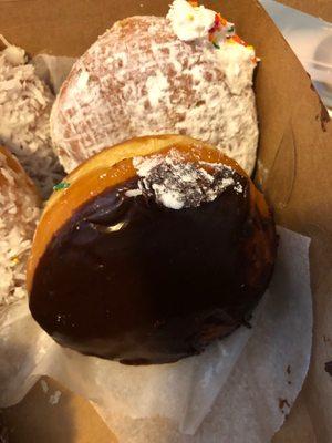 Big, fully and tasty cream filled and Boston cream donuts.