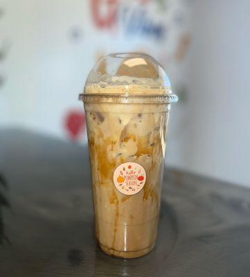 Iced protein coffee, pumpkin spice with caramel on the cup.