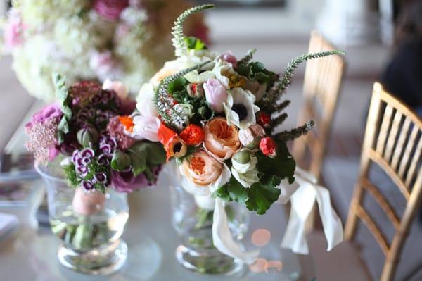 Spring bouquet of Juliet garden roses, anemones, poppies, Veronica and geranium leaves. Finished with ivory satin bow.