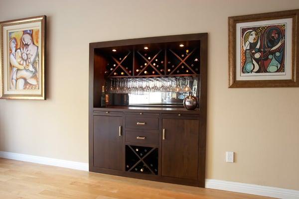 We helped our client turn a so-so alcove into a hip, cocktail bar - space below for the wine fridge and glamorous stemware storage above.