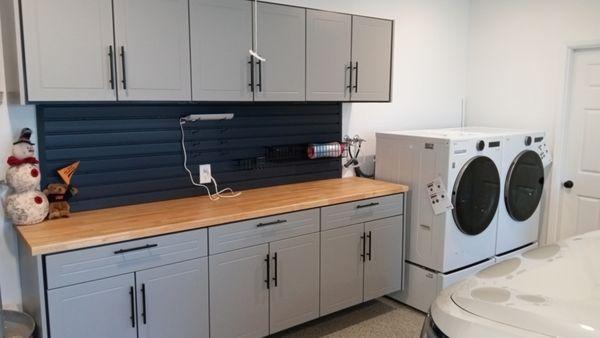 Butcher block counter, slatwall and cabinets