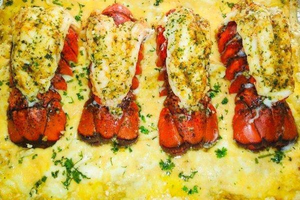 Seafood lasagna topped with lobster.