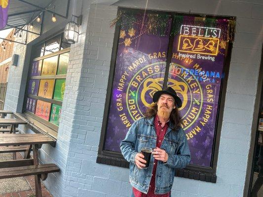 Charlie peruses the window wrap at Brass Monkey.