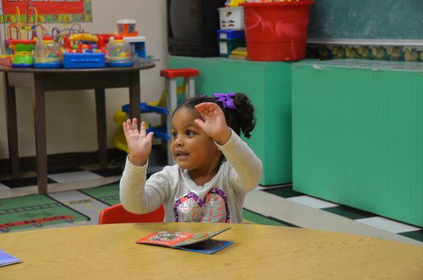 One of our 2 Year Olds singing and doing motions for the song: "The Wheels on the Bus Go Round and Round.