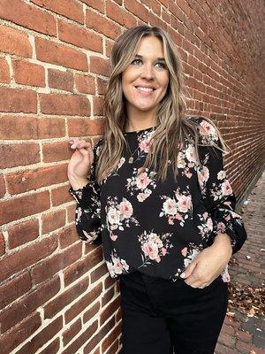 Ready for work in this black print top.