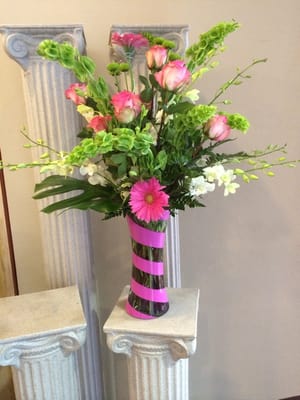 Pink roses, pink gerberas, white dendrobien orchids.