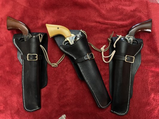 Set of holsters for Colt "clone" open-top revolvers.  Cross-draw holster in the middle