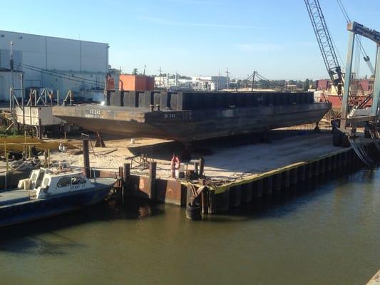 An oil field waste barge in for repairs