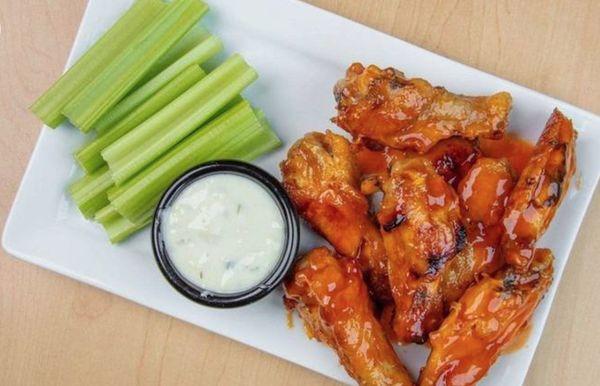 CHICKEN WINGS 
8 pieces of bone-in chicken wings tossed in our homemade buffalo sauce, then baked to perfection. Blue cheese + celery.