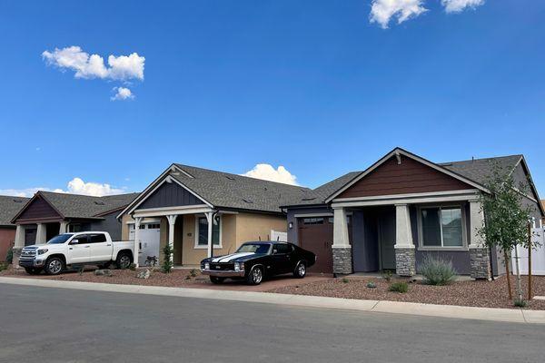 Single-family homes with attached garages, private driveways, and front porch entries.