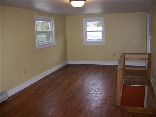 Home remodel.  Upstairs bedroom w/ new walls, windows, laminate flooring, trim work and paint.