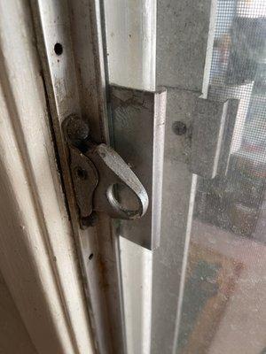 This is a close-up picture of the patio door lock/handle, which is broken.