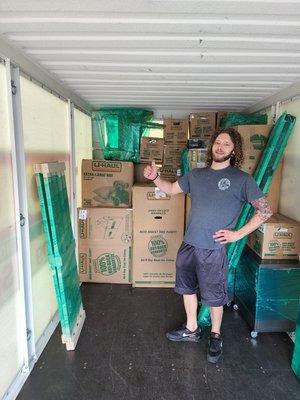 Dustin posing while a pod is being stacked. We load and unload all containers and trucks!