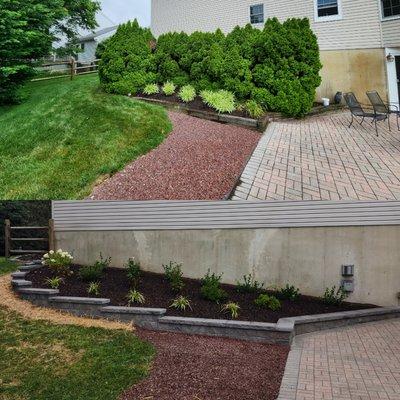 Complete landscaping renovation and old wood wdge replace with a long lasting paver retaining wall.