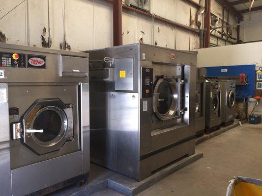 Our biggest washer in the middle of the picture 250lbs per load!