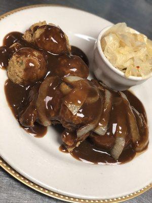 Porkchops smothered in onions and gravy! With a side of cornbread dressing and cabbage!